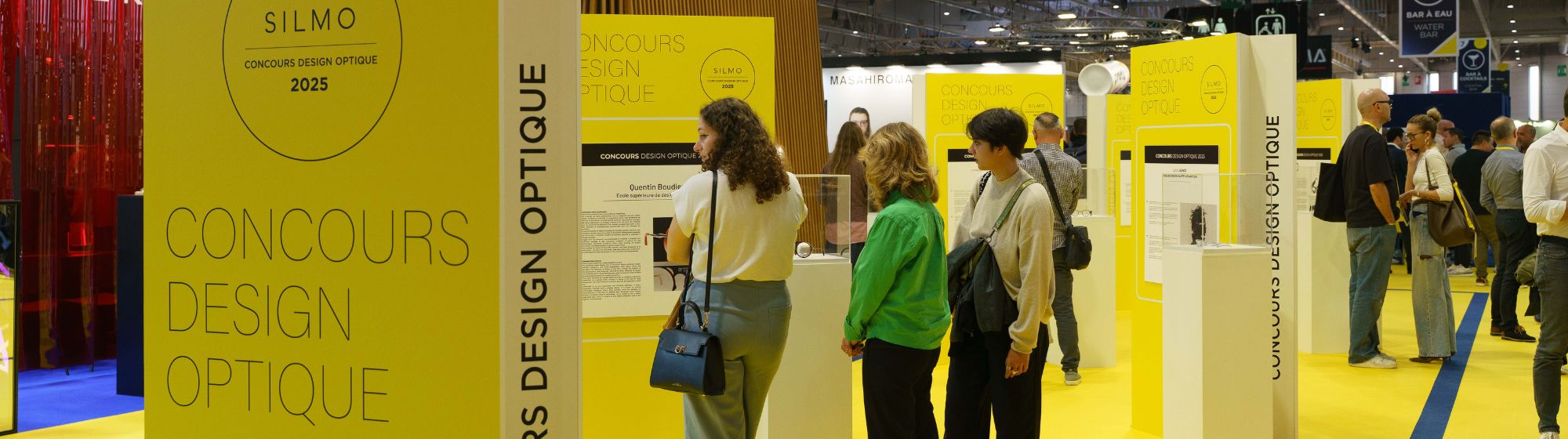 Visitors looking at the finalist projects of the Optical Design Contest