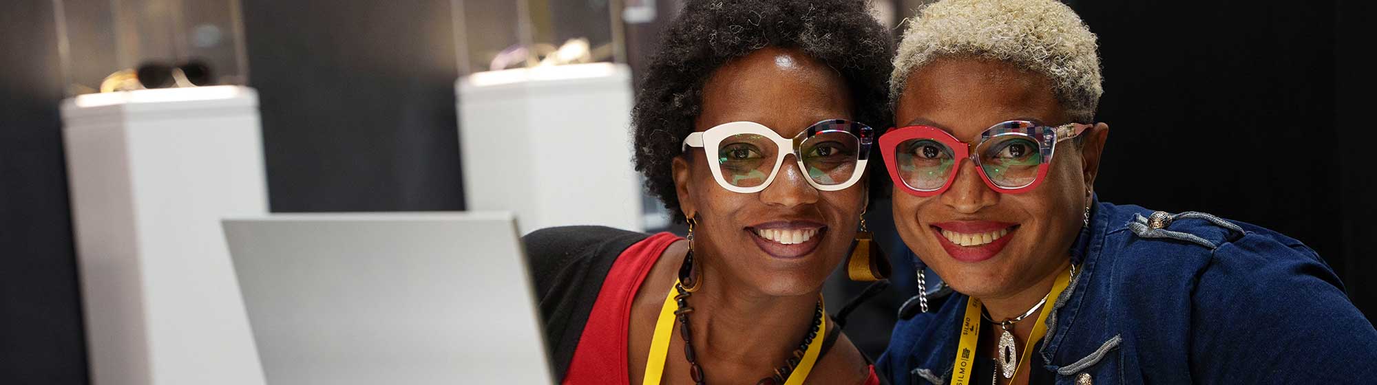 Two women smiling with glasses