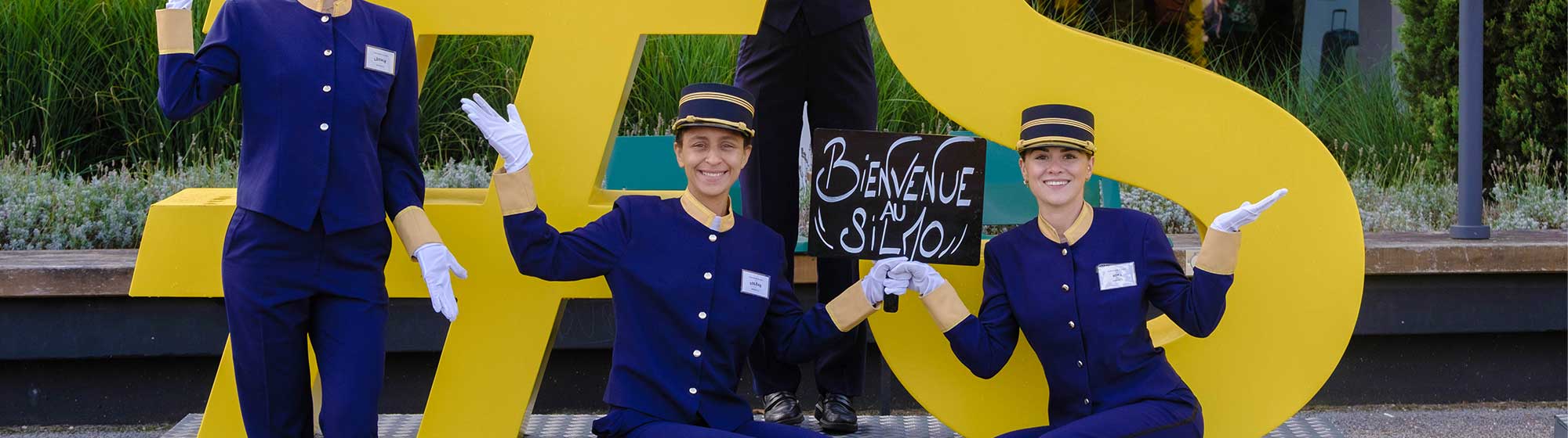 Hôtesses souriant et souhaitant la bienvenue aux visiteurs