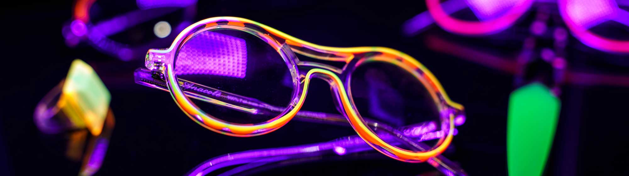 Purple glasses on a black background
