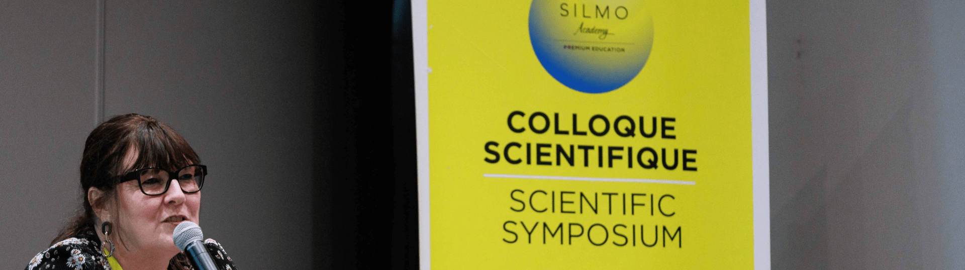 Woman speaking at SILMO Paris scientific symposium