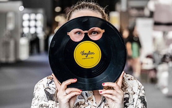 Woman holding a vinyl cutout in the shape of glasses