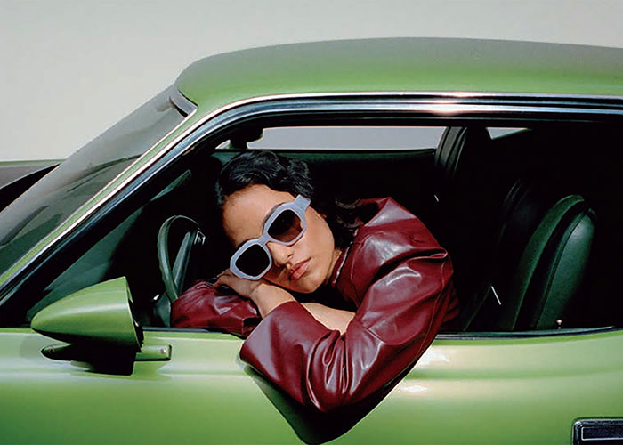 Woman driving a green car