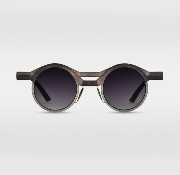 Round wooden sunglasses with dark lenses, winner of the Silmo d'Or 2021 in the Designer Sunglasses category